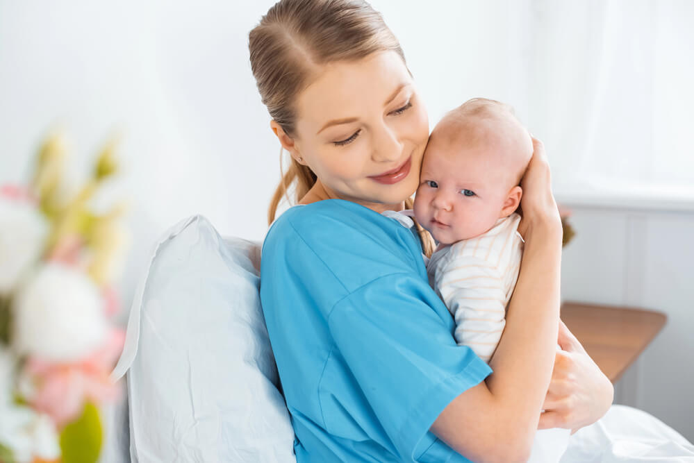 A woman holding a baby. Check here the 11 quick job certifications that pay well.