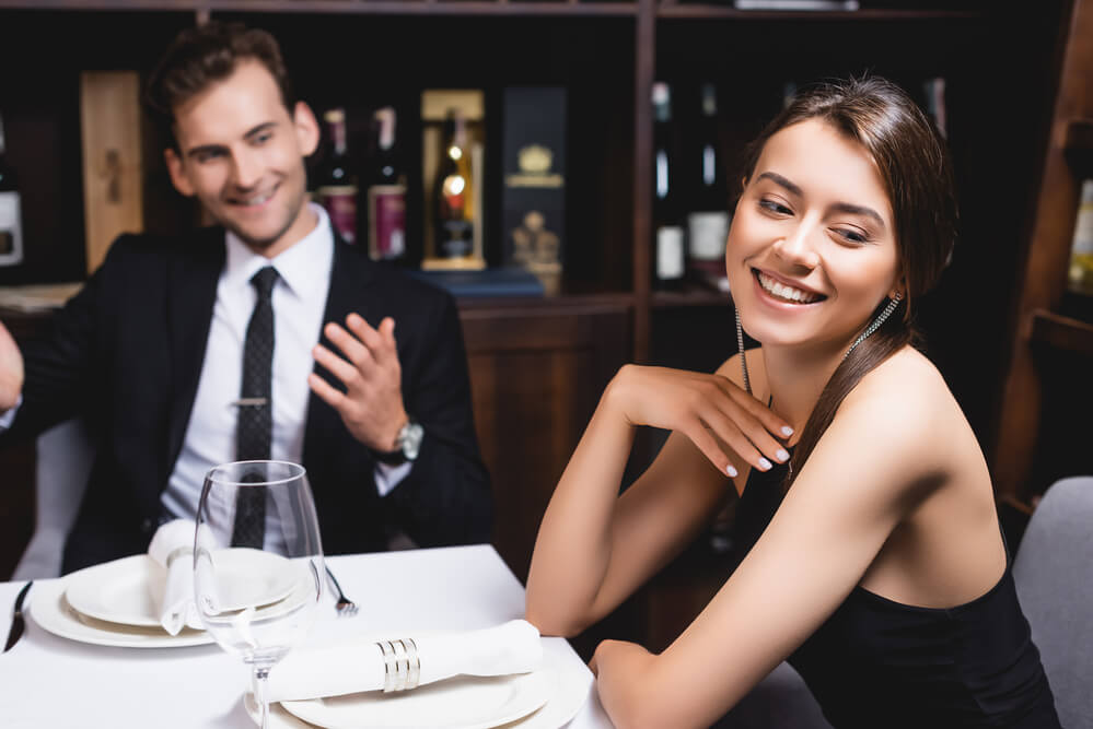 A man and woman laughing while on a date. Here are 5 tips for dating after divorce and what I wish I knew.