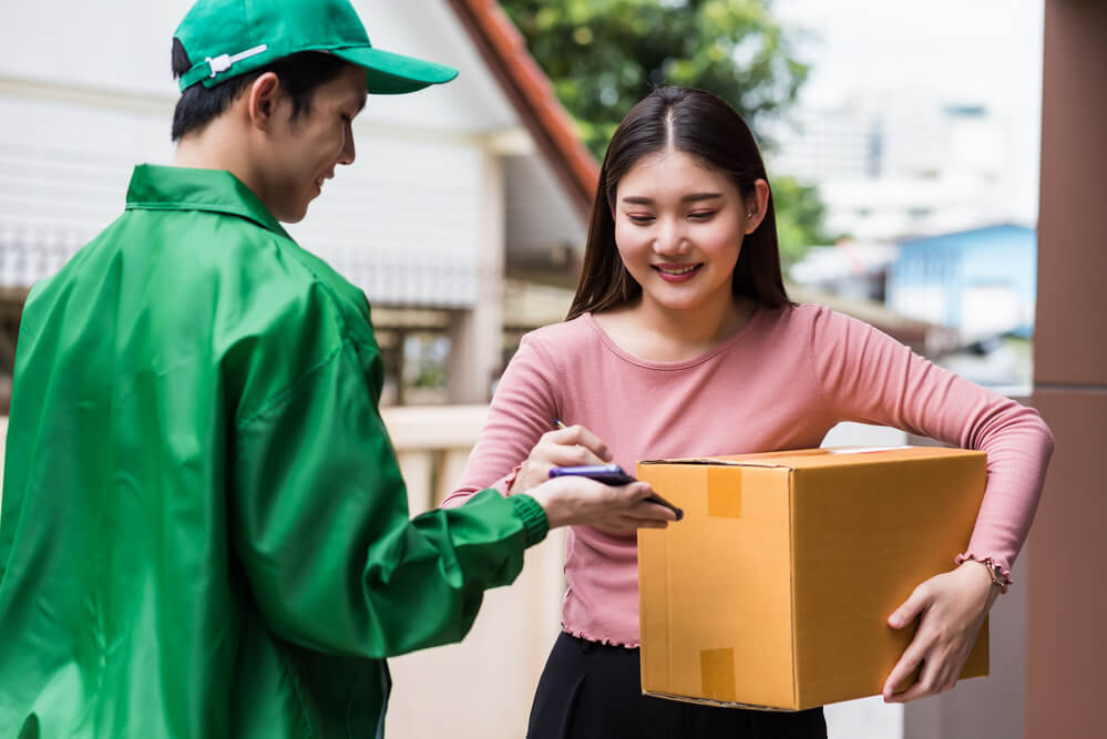 A delivery man drops off a package. Delivery services are considered a recession-proof business.