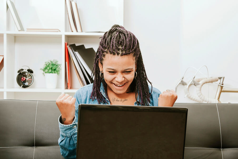 The woman feels happy about what she saw on the internet. You, too, can be happy if you score free appliances in platforms like Buy Nothing Project.