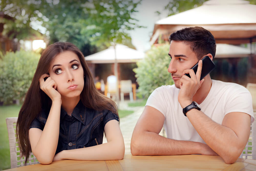 A woman looks suspicious while his man talks with someone on the phone. Normal relationship rules don't apply if you're in a friends with benefits relationship.