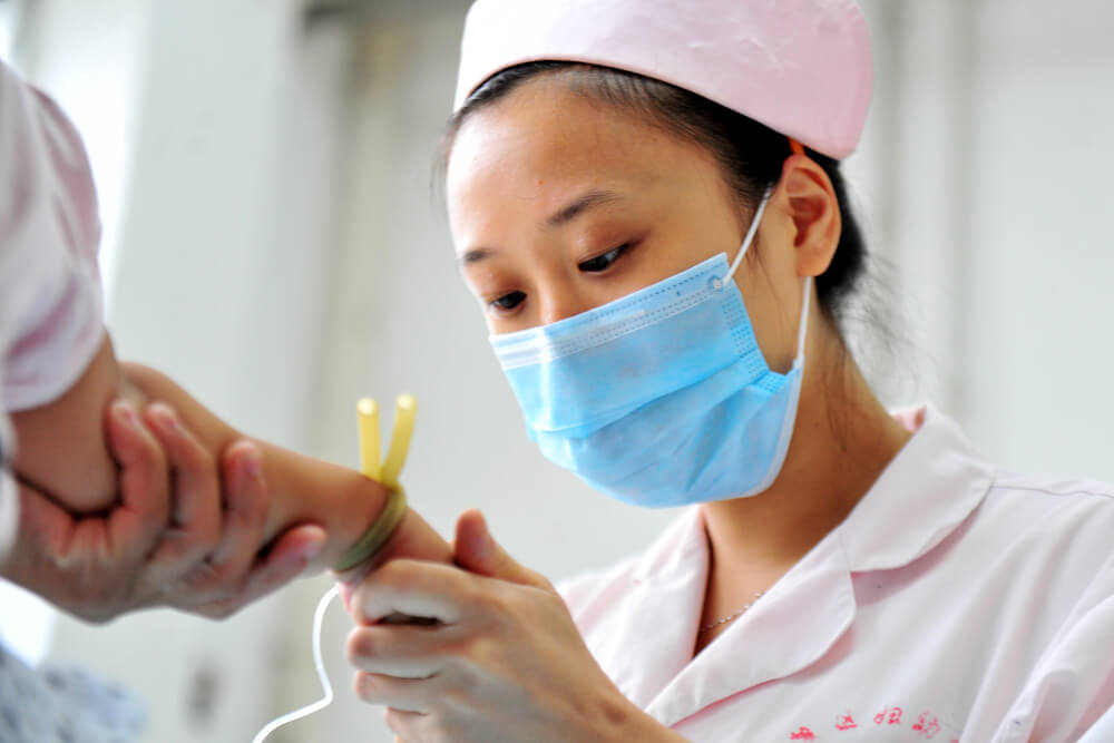 A Chinese nurse inserting an IV. Going back to school at 30 or 40: Is it worth it for single moms? Read here.