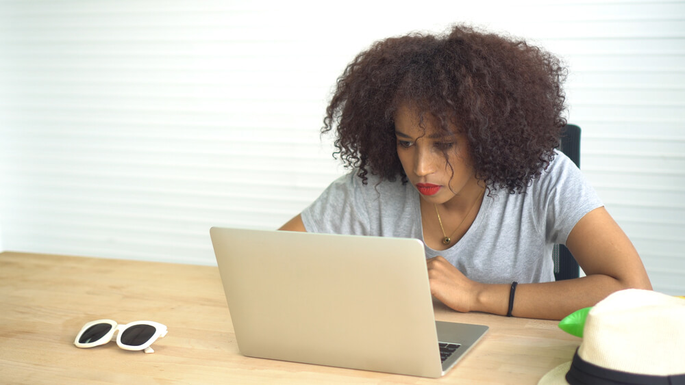 The woman changes email on her laptop. You need to have a separate email address and change passwords to receive correspondence from lawyers.