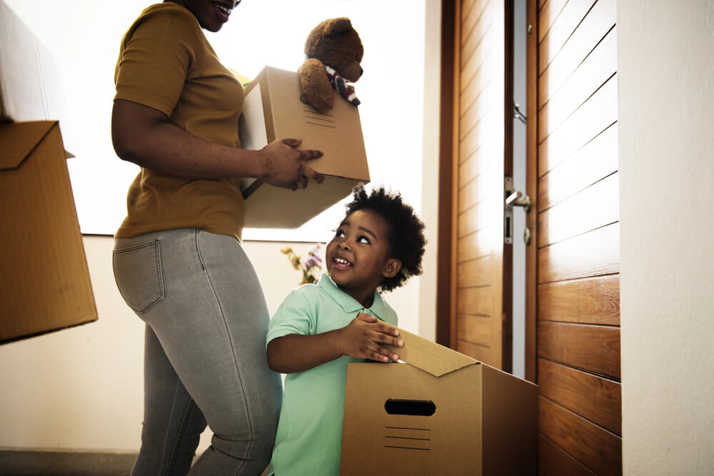 A mother and her son carry boxes out of their home on a post about free movers.